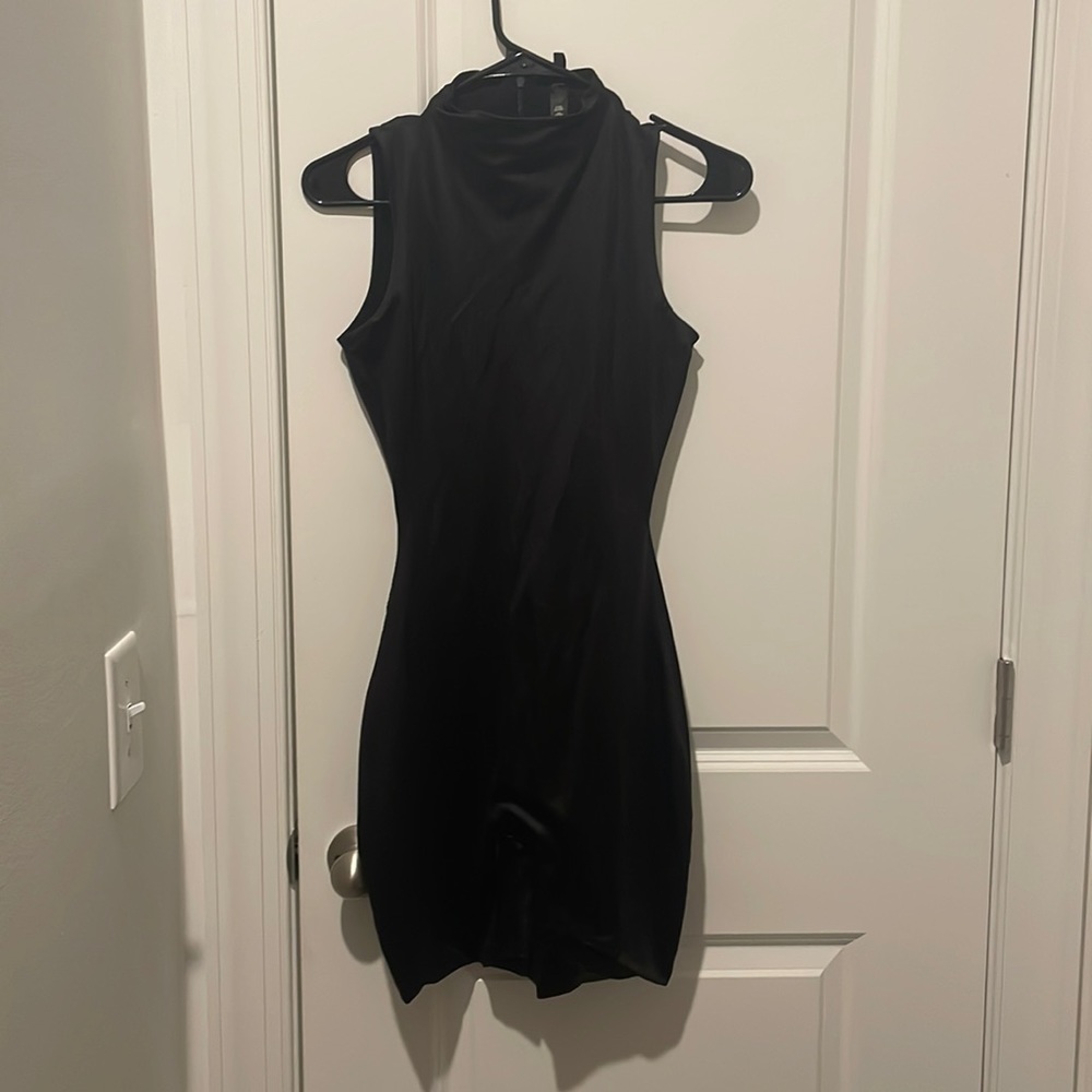 SKIMS black onsie. Worn one time, dry cleaned. Mock neck, no sleeves.